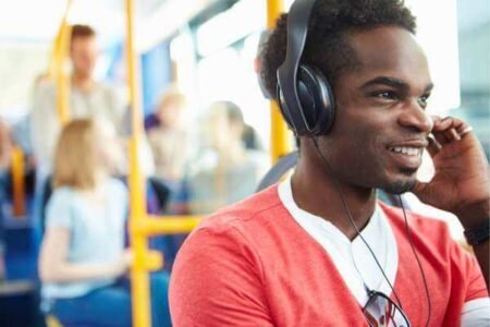 man wearing open back headphones in the bus